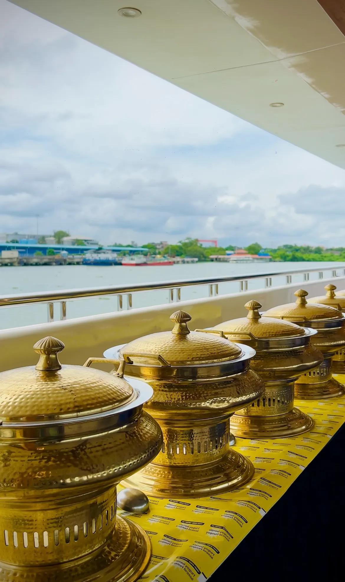 Buffet setup on a Minar Cruise catamaran with a view of Kochi harbor
